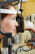 Woman at eye examination with slit lamp