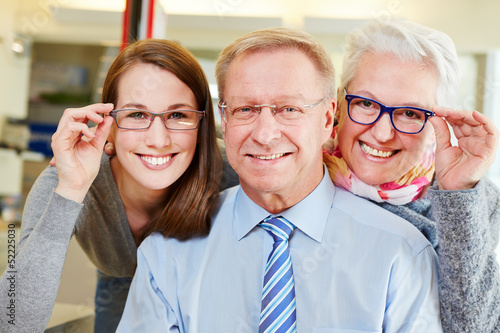 Photo: Family buying new glasses at optician Family buying new glasses at optician