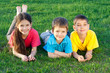 Photo: Three happy kids lying on the field Three happy kids lying on the field