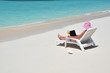 Girl with a laptop on the tropical beach. Exuma, Bahamas