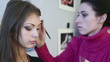 Making up the model for photo session in studio.