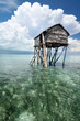 Bajau fisherman's wooden hut on sea water with blue sky