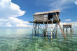 Bajau fisherman's wooden hut on sea water with blue sky