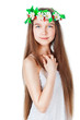 Portrait of a beautiful girl in a wreath, on a gray background
