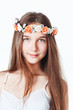 Portrait of a beautiful girl in a wreath, on a gray background