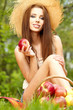 Beautiful woman in the garden with apples