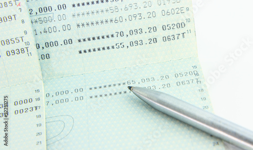 Photo: Account Passbook with a pen isolate Account Passbook with a pen isolate