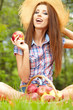 Beautiful woman in the garden with apples