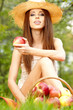 Beautiful woman in the garden with apples