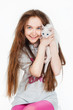 Portrait of a teenage girl with cat, on a gray background