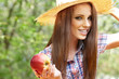 Beautiful woman in the garden with apples