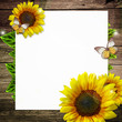 Illustration: blank paper with yellow sunflowers on wooden background blank paper with yellow sunflowers on wooden background