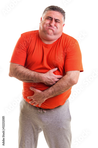 Photo: Overweight man with strong stomach pain Overweight man with strong stomach pain