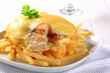 Cheese topped fish fillets with French fries