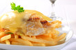 Cheese topped fish fillets with French fries