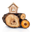 Wooden model of house and stack of wood. Concept