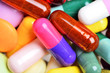 Many colorful pills isolated on white