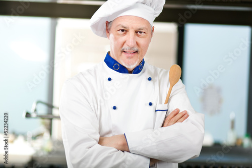 Photo: Male chef working in a restaurant kitchen Male chef working in a restaurant kitchen