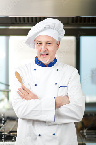 Photo: Male chef working in a restaurant kitchen Male chef working in a restaurant kitchen