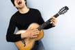 Happy man playing acoustic guitar