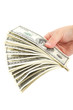 Hand holding a stack of money isolated on white background.