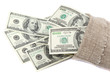 Hundred dollar bills in a canvas sack isolated on white backgrou
