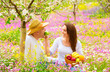 Foto: Young family in spring garden Young family in spring garden