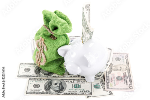 Photo: Piggy bank on the bills of American dollars isolated against whi Piggy bank on the bills of American dollars isolated against whi
