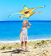 Kid flying kite outdoor.
