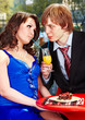 Couple eating cake in restaurant.