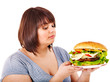 Woman eating hamburger.