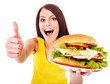 Woman holding hamburger.