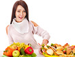Woman choosing between fruit and hamburger.