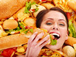 Woman eating hot dog.