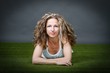 blonde woman lying on grass