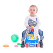 Young boy riding a toy car