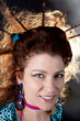 Portrait of a red haired woman smiling. Hairstyle