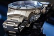 Luxury Watch over reflective surface, shallow depth of field