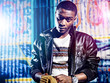 Black youth with jacket and colorful lights