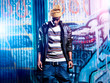 urban african american in front of graffiti wall