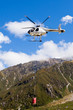 Transport helicopter fly over mountain wilderness