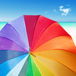 Photo: Colorful rainbow umbrella on a tropical beach Colorful rainbow umbrella on a tropical beach