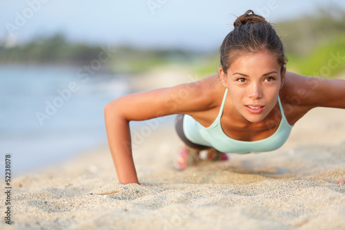 Photo: Push-ups fitness woman doing pushups outside Push-ups fitness woman doing pushups outside