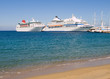 Two cruisers moored in a mediterranean harbor