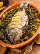 Baked crucian on a pillow from lentil and peas