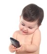 Beautiful baby playing and touching a smart phone