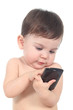 Beautiful baby playing and touching a mobile phone