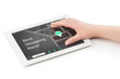 Woman's hand over a tablet computer.