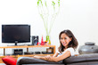 Young asian woman at home on the sofa