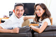 Asian couple at home in their living room